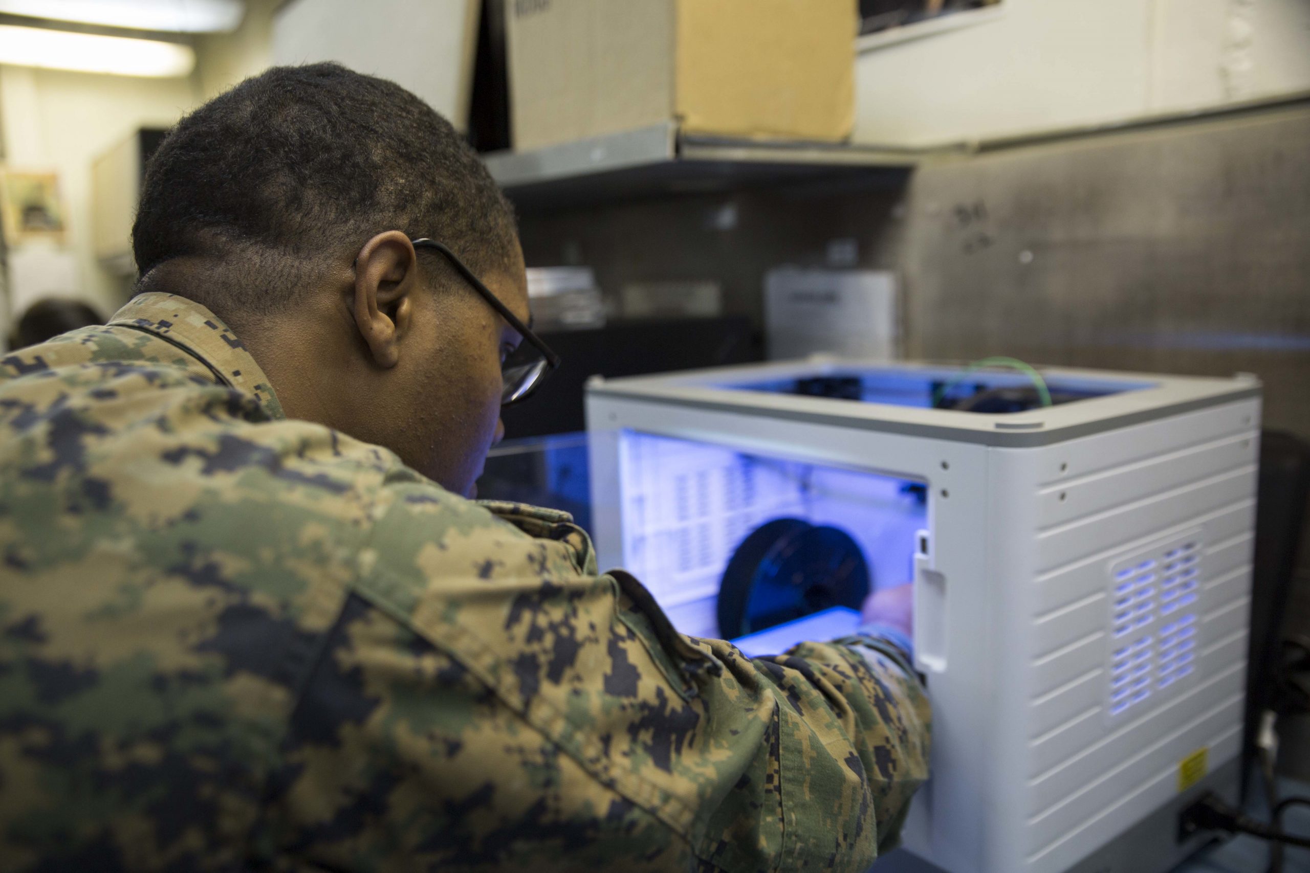 Sgt. Adrian Willis, a computer and telephone technician with Combat Logistics Battalion 31, 31st Marine Expeditionary Unit, prepares to print a 3-D model aboard the USS Wasp (LHD-1) while underway in the Pacific Ocean, April 7, 2018. Marines with Combat Logistics Battalion 31, 31st Marine Expeditionary Unit, are now capable of ‘additive manufacturing,’ also known as 3-D printing, which is the technique of replicating digital 3-D models as tangible objects. The 31st MEU partners with the Navy’s Amphibious Squadron 11 to form the Wasp Amphibious Ready Group, a cohesive blue-green team capable of accomplishing a variety of missions across the Indo-Pacific. (U.S. Marine Corps photo by Cpl. Bernadette Wildes/Released)